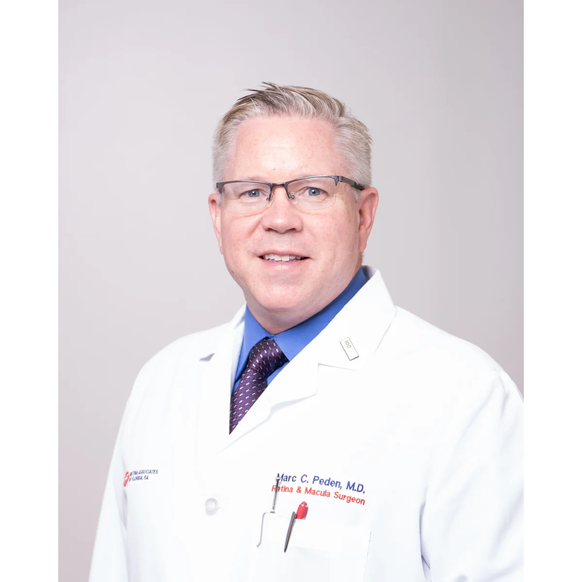 Individual professional headshot in navy blazer