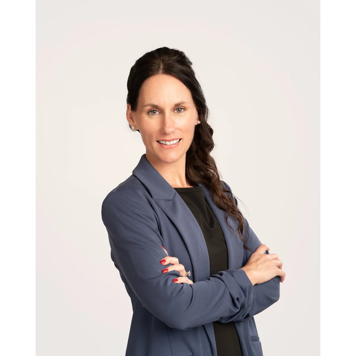 Corporate team headshot in white shirt and navy blazer